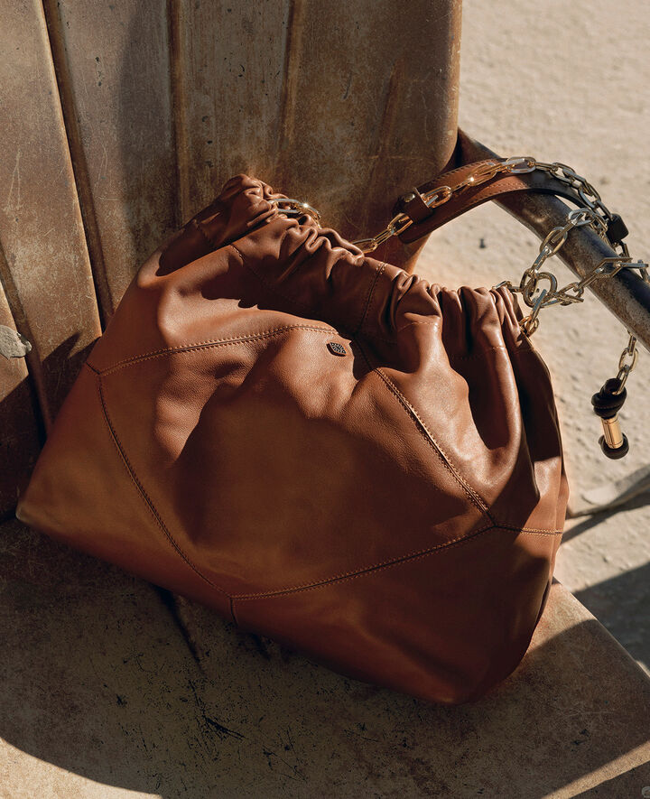 A woman and the brown iconic june tote bag